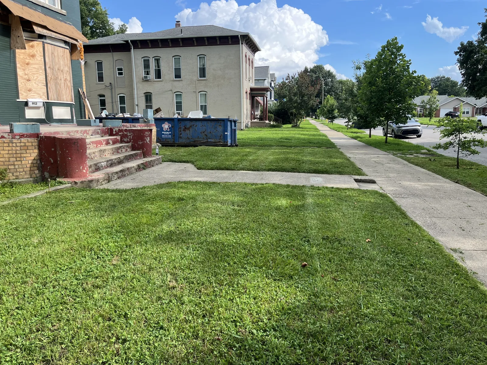 Clean lawn edging along a driveway and sidewalk